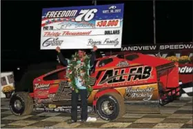  ??  ?? Jeff Strunk celebrates in victory lane after winning the Freedom 76 at Grandview Speedway on Saturday night.