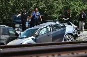  ?? JOSE CARLOS FAJARDO — STAFF PHOTOGRAPH­ER ?? Contra Costa sheriff's deputies examine the scene of a crash between an Amtrak train and a car on Sunday.