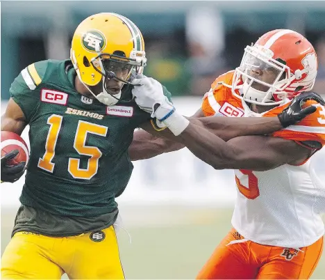  ?? JASON FRANSON/THE CANADIAN PRESS ?? Lions defensive back Buddy Jackson grabs the face mask of Edmonton wide receiver Vidal Hazelton during the first half at Commonweal­th Stadium in Edmonton, Friday. Hazelton scored a 108-yard touchdown in the game, the longest reception in Esks history.