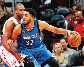  ??  ?? ATLANTA: Al Horford #15 of the Atlanta Hawks defends against Karl-Anthony Towns #32 of the Minnesota Timberwolv­es at Philips Arena on November 9, 2015 in Atlanta, Georgia.