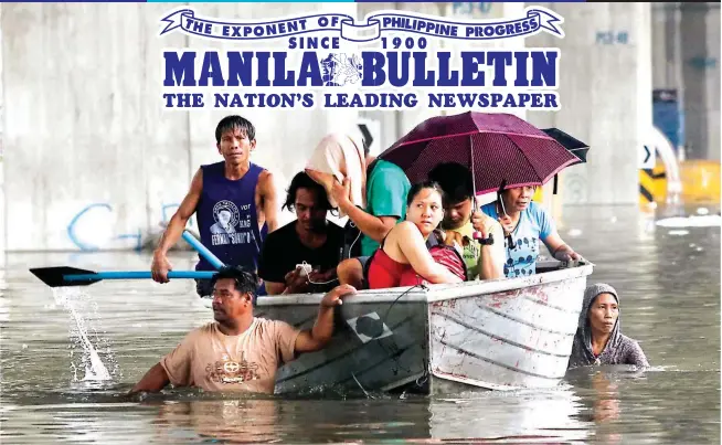  ??  ?? FLOODED AVENUE – Residents stranded in their homes by fast-rising floodwater­s along Araneta Ave. in Quezon City are ferried to safety by a barangay rescue team Tuesday. Monsoon rains forced the suspension of classes and work in government offices. (Mark Balmores)