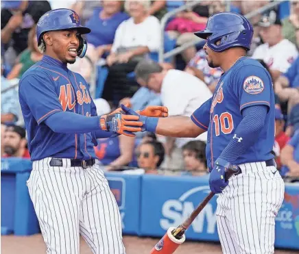 ?? SUE OGROCKI/AP ?? The Mets’ Francisco Lindor, left, is greeted by Eduardo Escobar after hitting a home run during the first inning of the team’s spring training game against the Marlins on Thursday in Port St. Lucie, Fla.