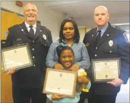  ?? STAFF PHOTO BY TIFFANY WATSON ?? A’Nasia Clayton, 8, dispatcher Ronald Lucas, left, and paramedic Paul Lenharr were recognized by the Charles County commission­ers at the Charles County Government building with lifesaving awards on Sept. 27. Janée Clayton, center, stands with her daughter.