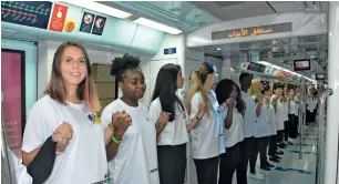  ??  ?? People of various nationalit­ies hold their hands to create a human chain inside the Dubai Metro to break a Guinness record. The previous record was of 75 nationalit­ies set in Norway in 2013.