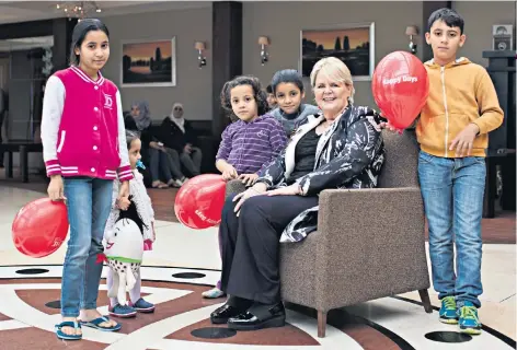  ??  ?? Open heart, open arms: Jackie Mullen with some of her young residents, above