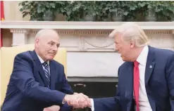  ?? — AFP ?? WASHINGTON: US President Donald Trump (right) shakes hands with newly swornin White House Chief of Staff John Kelly at the White House yesterday.