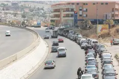  ?? (Aziz Taher/Reuters) ?? CARS WAIT in line to fuel up near a gas station last week in Jiyeh, Lebanon.