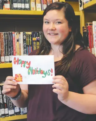  ?? [WHITNEY NEILSON / THE OBSERVER] ?? Grade 7 student Abbi Storey initiated a project at Elmira’s Park Manor Public School, which saw Grade 7 students craft homemade Christmas cards to send overseas to Canadian troops.