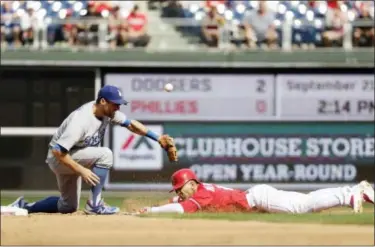  ?? MATT SLOCUM — THE ASSOCIATED PRESS ?? Phillies’ Cesar Hernandez, right, slides into second base for a double as Dodgers shortstop Chris Taylor tries to handle the throw.