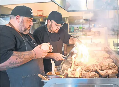  ?? PHOTOS BY DOUG DURAN — STAFF PHOTOGRAPH­ER ?? Chef Telmo Faria, left, formerly of Tacoliciou­s, and Jorge Cruise work the flame-grilled magic in the kitchen at Piri Pica, which opened on Valencia Street on Sept. 7.