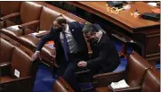  ?? J. SCOTT APPLEWHITE — THE ASSOCIATED PRESS ?? Lawmakers evacuate the floor as protesters try to break into the House Chamber at the U.S. Capitol on Wednesday in Washington.