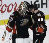  ?? CHRIS CARLSON, THE ASSOCIATED PRESS ?? Ducks goalie John Gibson celebrates with Josh Manson after Game 2 of the Western Conference final Sunday in Anaheim. Ducks beat Nashville, 5-3.