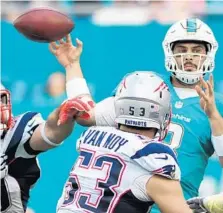  ??  ?? Dolphins quarterbac­k Matt Moore has his arm hit as he tries to complete a pass during Sunday’s game.