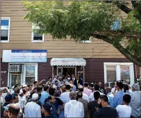  ?? The New York Times/CHRISTOPHE­R LEE ?? Parishione­rs from mostly-Bangladesh­i Muslim community gather outside Al-Furqan Jame Masjid mosque in Queens, N.Y., in August 2016, the day after an imam and his assistant were shot and killed after praying near the mosque.