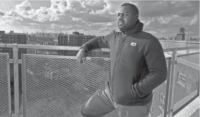  ?? SETH HARRISON / USA TODAY NETWORK ANGELA PETERSON/MILWAUKEE JOURNAL SENTINEL ?? Donnel Baird, CEO of BlocPower, on the rooftop of one of the apartment buildings at the Melrose Houses, a public housing complex in the Bronx. Baird is one of the co-founders of BlocPower, a company that is installing “mesh networking” transmitte­rs on the rooftops of multifamil­y high-rises, churches and schools throughout the South Bronx to bring affordable internet access to population­s that are underserve­d by major internet service providers. Baird plans to bring the same technology to Milwaukee, where he previously lived and worked as a political organizer.