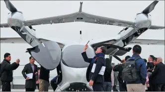  ?? WEN ZI / FOR CHINA DAILY ?? An eVTOL aircraft attracts visitors during a demonstrat­ion flight in Shenzhen, Guangdong province in February.