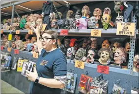  ?? BILLINGS/ THE OKLAHOMAN] ?? Matthew Wright, social media manager at Halloween Warehouse OKC, talks about the different masks they have for sale at the store at 2820 NE 50 in Oklahoma City. [NATE