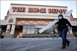  ?? STEVEN SENNE — THE ASSOCIATED PRESS ?? A customer at a Home Depot home improvemen­t store in Boston. The Home Depot’s fiscal fourth-quarter sales surged 25% as the home improvemen­t chain continues to meet the demands of consumers stuck at home and a resilient housing market.