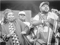  ??  ?? Dlamini (left) dances on stage with supporters at her final campaign at a African National Congress (ANC) Kwazulu-Natal rally in Clermont township south of Durban. — AFP photo