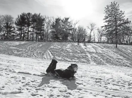  ?? FRED SQUILLANTE/COLUMBUS DISPATC ?? Sledding allows people to see the beautiful parks around central Ohio in a new light and during a different time of year, according to Jason Meyers, park manager at Alum Creek State Park.