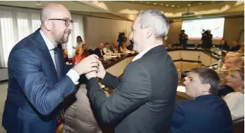  ?? — AFP ?? Belgian Prime Minister Charles Michel (L) receives eggs from Philippe Duvivier of Fugea ahead of a meeting between the prime minister and delegates from the egg and chicken industry in Houffalize on Thursday.