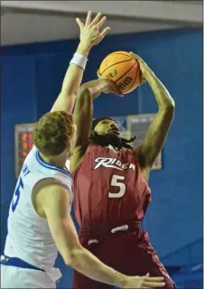  ?? KYLE FRANKO — TRENTONIAN PHOTO ?? Rider’s Mervin James, right, lays the ball up over the defense of Delaware’s Christian Ray, left, during an NCAA men’s basketball game on Wednesday night at the Bob Carpenter Center in Newark, Del.