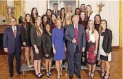  ??  ?? The OU softball team stands for a photo with President Donald Trump and Education Secretary Betsy DeVos.