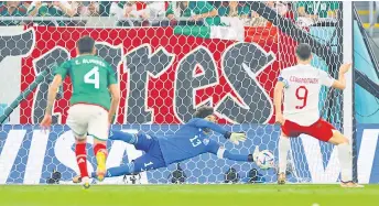  ?? — AFP photo ?? Mexico goalkeeper Guillermo Ochoa saves a penalty shot by Lewandowsk­i.