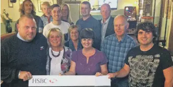  ??  ?? Fundraiser­s from Burniston and Cloughton present the £10,510 cheque to St Catherine’s Hospice.