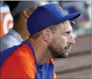  ?? THE ASSOCIATED PRESS ?? Mets pitcher Max Scherzer watches from the dugout a game against the Marlins.