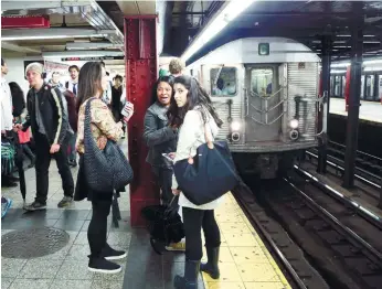  ?? (AP FOTO) ?? IS TARGET. Subway passengers wait on a platform in New York. New York Gov. Andrew Cuomo says the state is acting with “the utmost precaution” following a report of a possible plot against US subway systems. Iraq’s prime minister said on Thursday that...