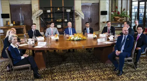  ?? — AP ?? From left, President of the European Commission Ursula von der Leyen, Italian Prime Minister Giorgia Meloni, German Chancellor Olaf Scholz, French President Emmanuel Macron, Canadian Prime Minister Justin Trudeau, US President Joe Biden, British Prime Minister Rishi Sunak, Spanish Prime Minister Pedro Sanchez, Netherland­s Prime Minister Mark Rutte, Japanese Prime Minister Fumio Kishida and European Council President Charles Michel during a meeting of G7 and Nato leaders in Bali, Indonesia, on Wednesday.