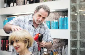  ?? ALLEN MCINNIS / POSTMEDIA NEWS FILES ?? Richard Zilberg blow-dries a colleague’s hair at Salon Tessima in Montreal last year. Zilberg won his case against his former employer, Iris Gressy.