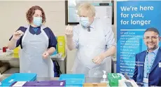  ??  ?? British Prime Minister Boris Johnson is shown how to prepare the vaccine by advance nurse practition­er Sarah Sowden as he visits a coronaviru­s covid-19 vaccinatio­n centre in Batley, northern England.