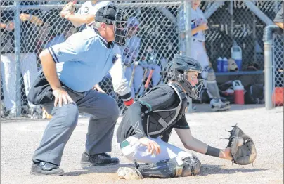  ?? JASON SIMMONDS/JOURNAL PIONEER ?? Team P.E.I. catcher Duncan Picketts receives a pitch as home-plate Wayne Hein is about to make a call during play in the 2017 Ray Carter Cup at Queen Elizabeth Park in Summerside on Thursday afternoon. British Columbia defeated Team P.E.I. 7-3 in the...