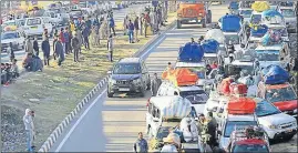  ?? PTI ?? Vehicles stranded on the JammuSrina­gar highway near Nagrota due to landslides triggered by incessant rains and fresh snowfall on Wednesday.