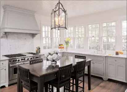  ?? John McDonnell/Washington Post ?? Washington architect Christophe­r Snowber designed this kitchen for the Chevy Chase, Md. home of Amy and Richard Zantzinge; wood floors rule in remodeled kitchens.