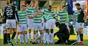  ??  ?? Hayes feeling the hurt: Celtic winger receives treatment on the turf