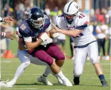  ?? JiM MicHAuD pHOTOS / bOSTOn HerAlD ?? DOWN TO THE WIRE: Belmont Hill’s Sean Egan gets stopped by a couple of Lawrence Academy defenders including Henry Graf (40) during the first half Saturday in Belmont. At left, Lawrence Academy QB Ryan Puglisi runs during the first half.