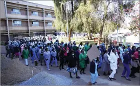  ?? AP PHOTO/TSVANGIRAY­I MUKWAZHI ?? FILE -Health workers led by nurses take part in a demonstrat­ion over salaries at Parerenyat­wa Hospital in Harare, on June, 21, 2022. As food costs and fuel bills soar, inflation is plundering people’s wallets, sparking a wave of protests and workers’ strikes around the world.