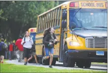  ?? Erik Trautmann / Hearst Connecticu­t Media ?? Norwalk High School students catch their buses after school in 2017.