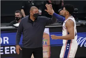  ?? RICH PEDRONCELL­I — THE ASSOCIATED PRESS ?? 76ers head coach Doc Rivers, left, gives a high-five to forward Tobias Harris in the closing moments of a 119-111victory over the Sacramento Kings last month. Rivers said the 76ers have a chance to be ‘great.’