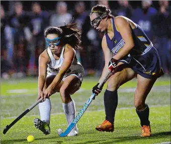  ?? SARAH GORDON/THE DAY ?? Stonington’s Miranda Arruda (20) hits a ball past Woodstock Academy’s Hannah Reynolds during the 2017 ECC tournament semifinals. Arruda, who scored 24 goals and was named The Day’s All-Area Player of the Year, returns for the Bears, who will try to win their 10th straight ECC title.