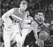  ?? Darren Abate / Associated Press ?? The Spurs’ Tre Jones, right, and the Wizards’ Davis Bertans chase the ball during the first half.