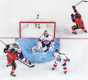  ?? PICTURE: USA TODAY Sports ?? Calgary Flames right wing Michael Frolik (right) celebrates his goal as Florida Panthers goaltender Roberto Luongo looks on during their NHL game at Scotiabank Saddledome.