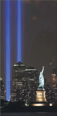  ?? Brian Branch-Price / Associated Press ?? The Tribute in Light shines over the Manhattan skyline and the Statue of Liberty in New York on Sept. 11, 2004.