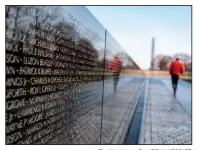  ?? The Washington Post/CELIA KESSLER ?? Afternoon is the best time for somber reflection at the Vietnam Veterans Memorial.