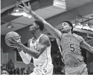  ?? Marco Garcia / Associated Press ?? Auburn’s Chuma Okeke, right, tries to stop Duke’s RJ Barrett from going to the basket Tuesday night.