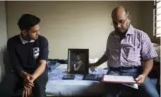  ?? MARTA IWANEK/TORONTO STAR FILE PHOTO ?? Gautam Tiwari, 17, and father Rakesh Tiwari sit in Prashant Tiwari’s bedroom. Prashant, 20, died under 24-hour hospital surveillan­ce.