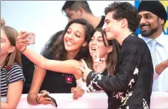  ?? — AFP photos ?? Chalamet greets fans and takes selfies with them at the premiere of ‘Beautiful Boy’ at the Toronto Internatio­nal Film Festival in Toronto, Ontario, on Friday.